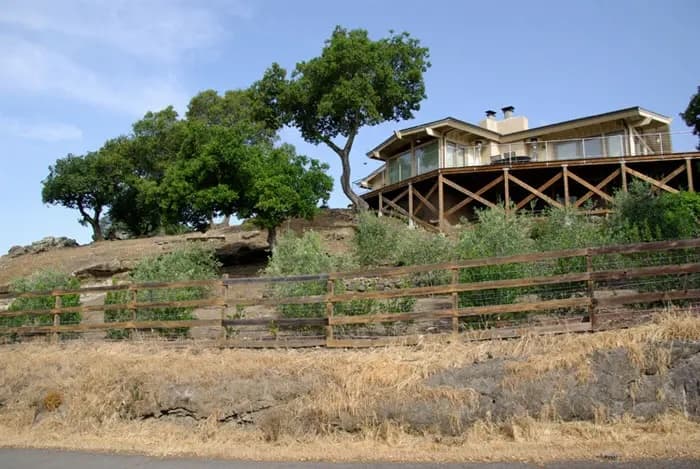 Before-and-after of defensible space work around a foothills home