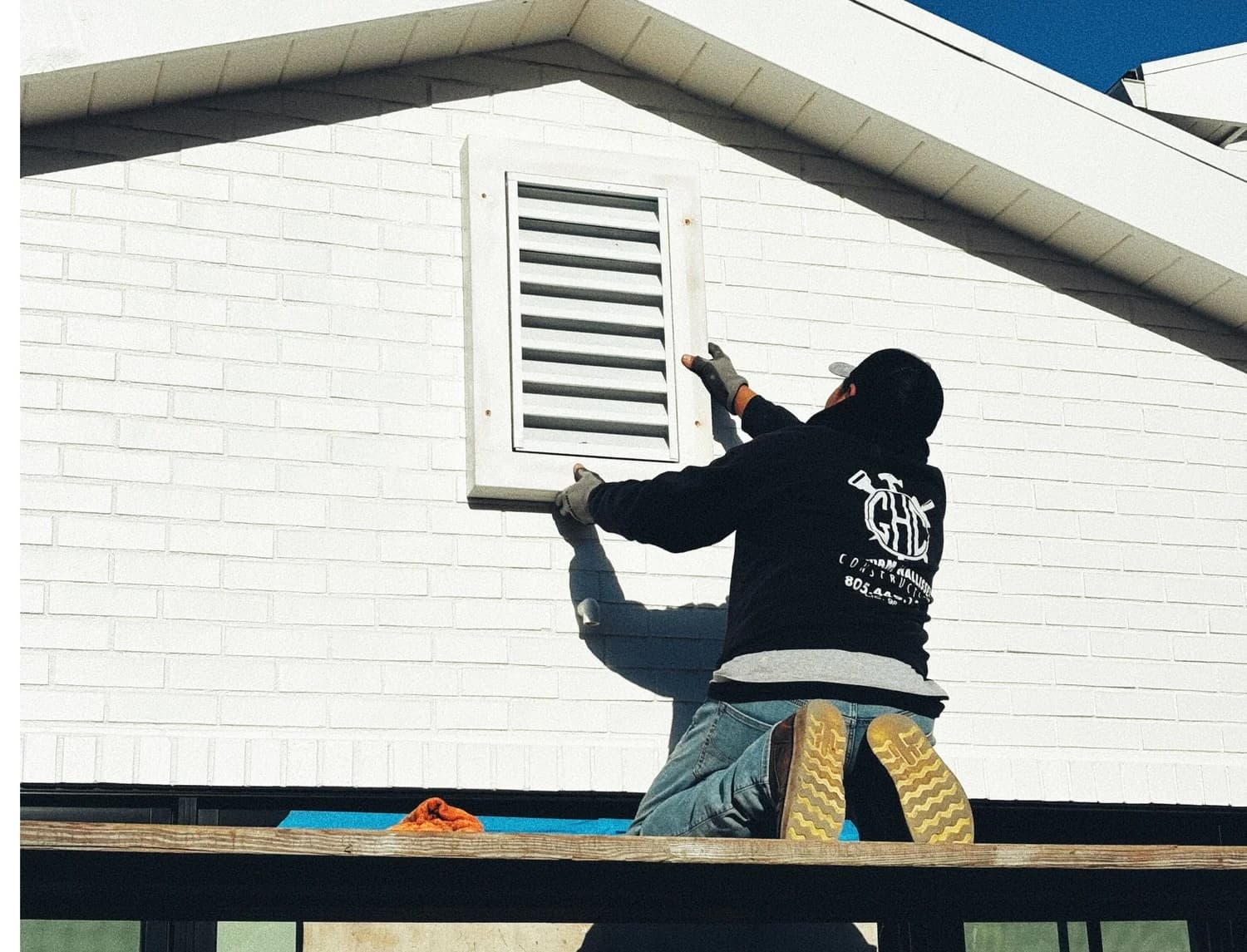 Inspector examining roof and vent ember-vulnerability points